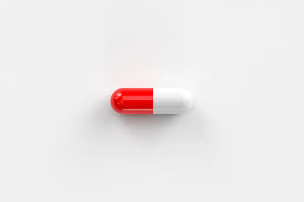 A red and white capsule pill.