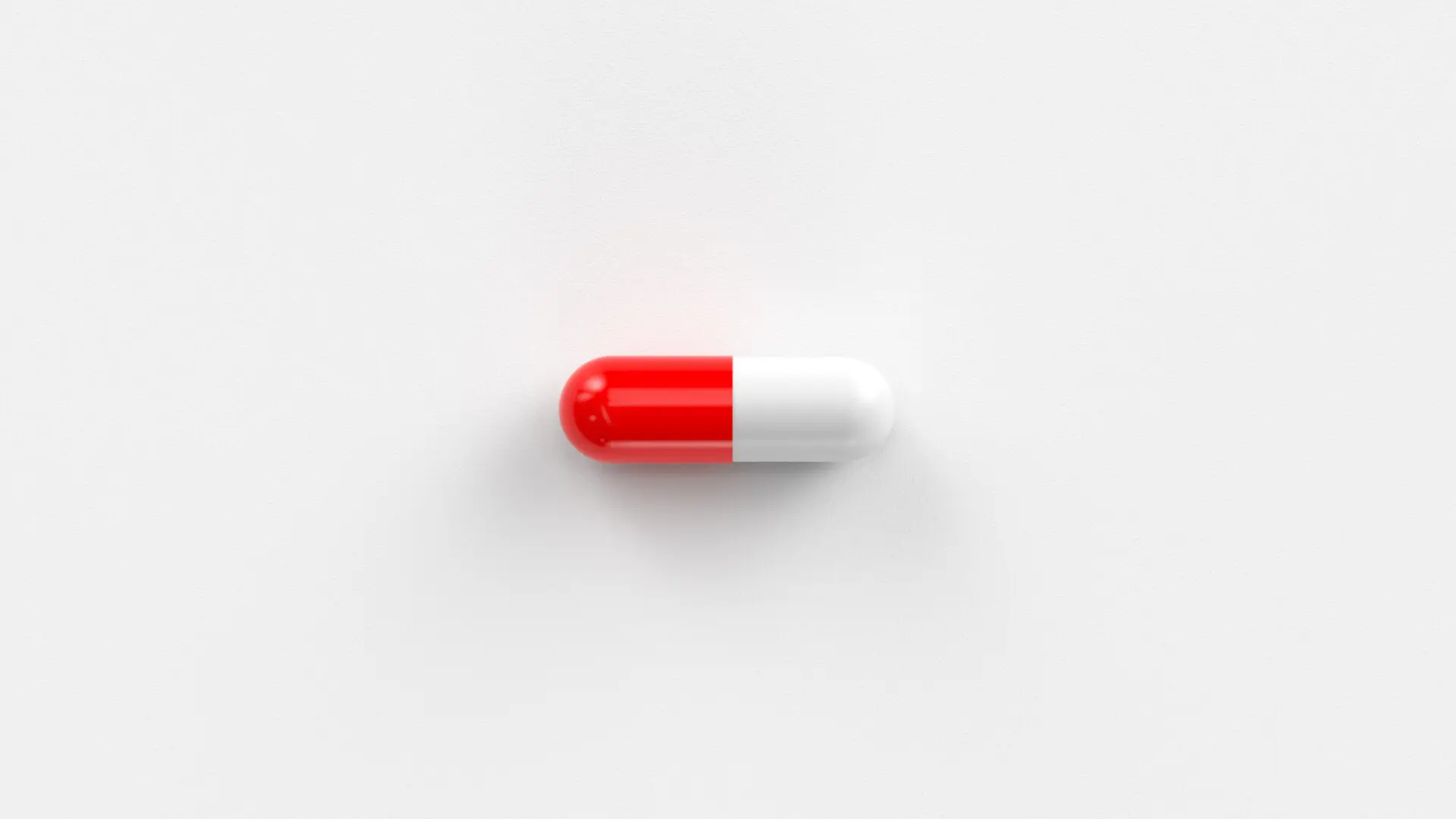 A red and white capsule pill.