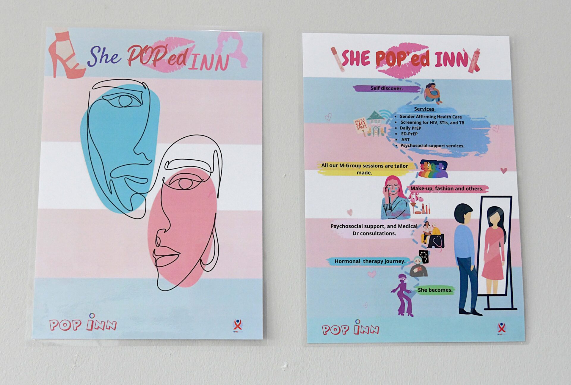 Two pink and blue posters about empowerment in the offices of TB HIV Care, which speak about the trans community accepting who they are.