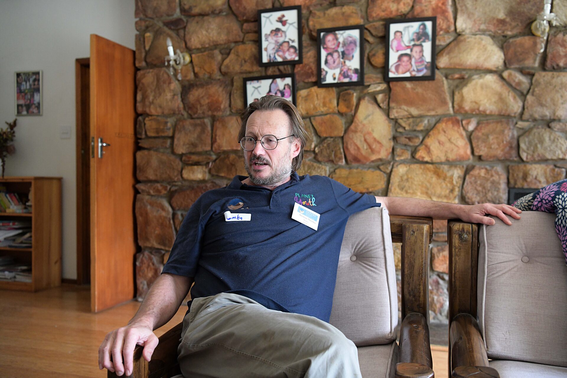 Dr Hermann Reuter sitting on a cough at his home in George.