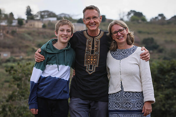 Dr Hennie Hamilton smiles with his arm around his wife Sylivia and son John.