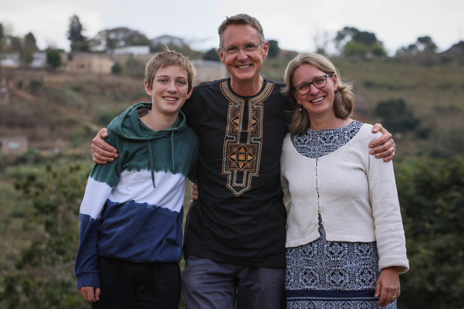 Dr Hennie Hamilton smiles with his arm around his wife Sylivia and son John.