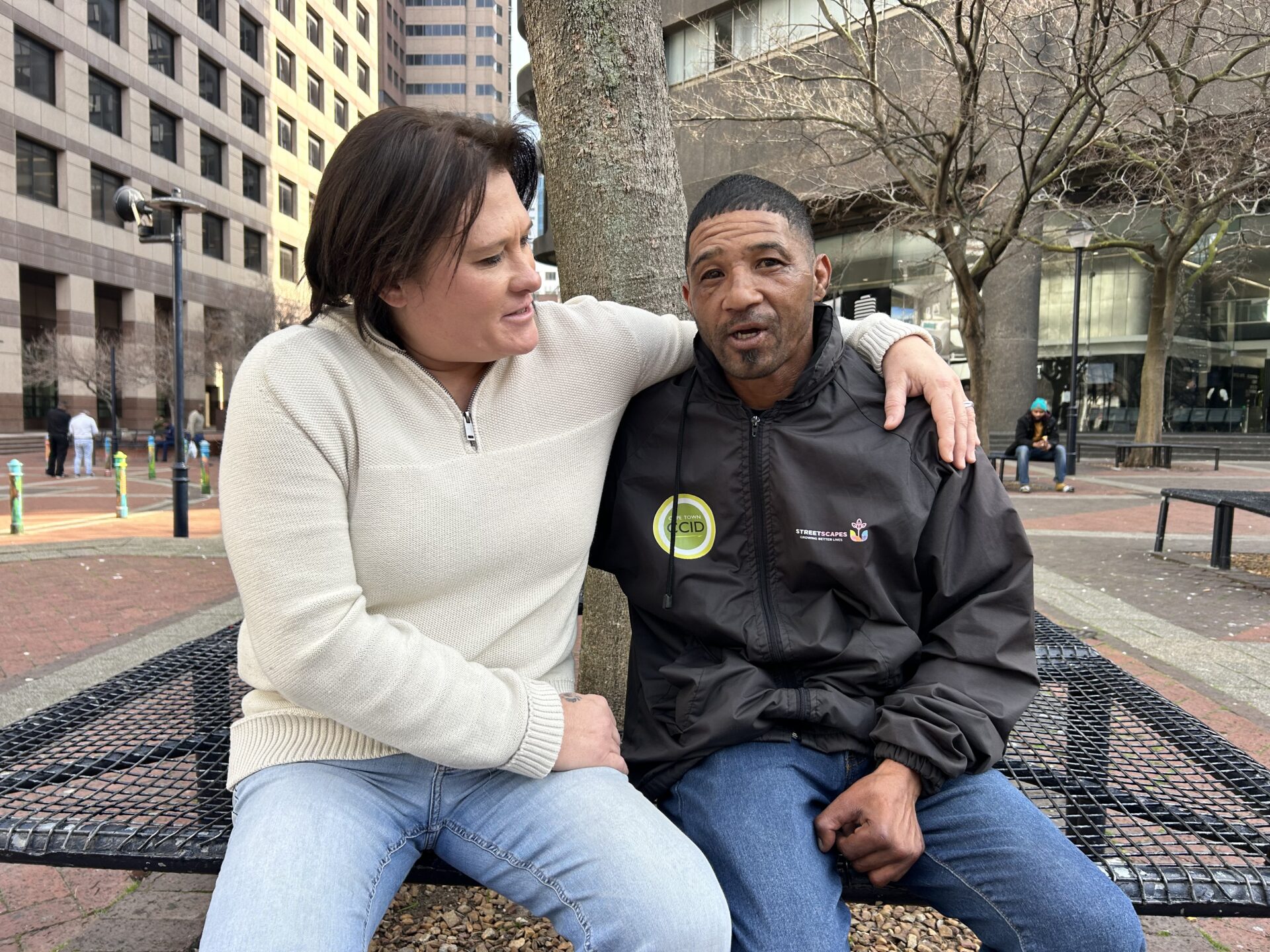 Tara Gerardy-Bissolati and Eugene Meyer sitting on a bench in central Cape Town.