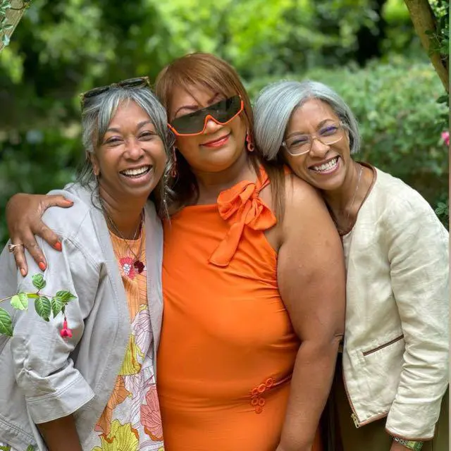 Liesl Zuhlke in a warm embrace with her two sisters Wendy Canterbury and Sam Page.