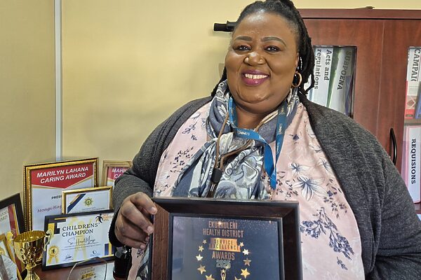 Specialist forensic nurse Hazel Moagi inside her office at Bertha Gxowa Care Centre holding up one of the many certificates she has won.