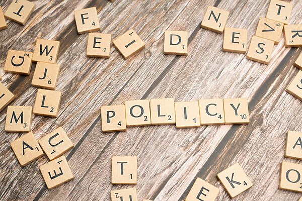 "policy" spelled out with scrabble tiles