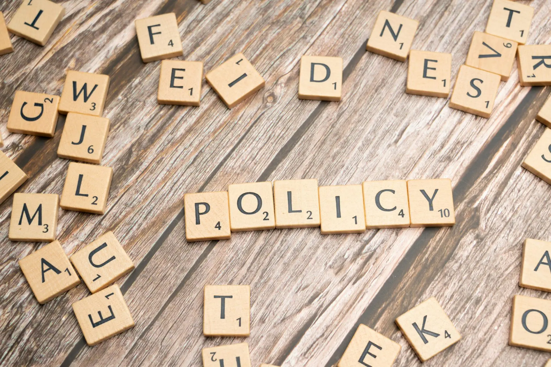 "policy" spelled out with scrabble tiles