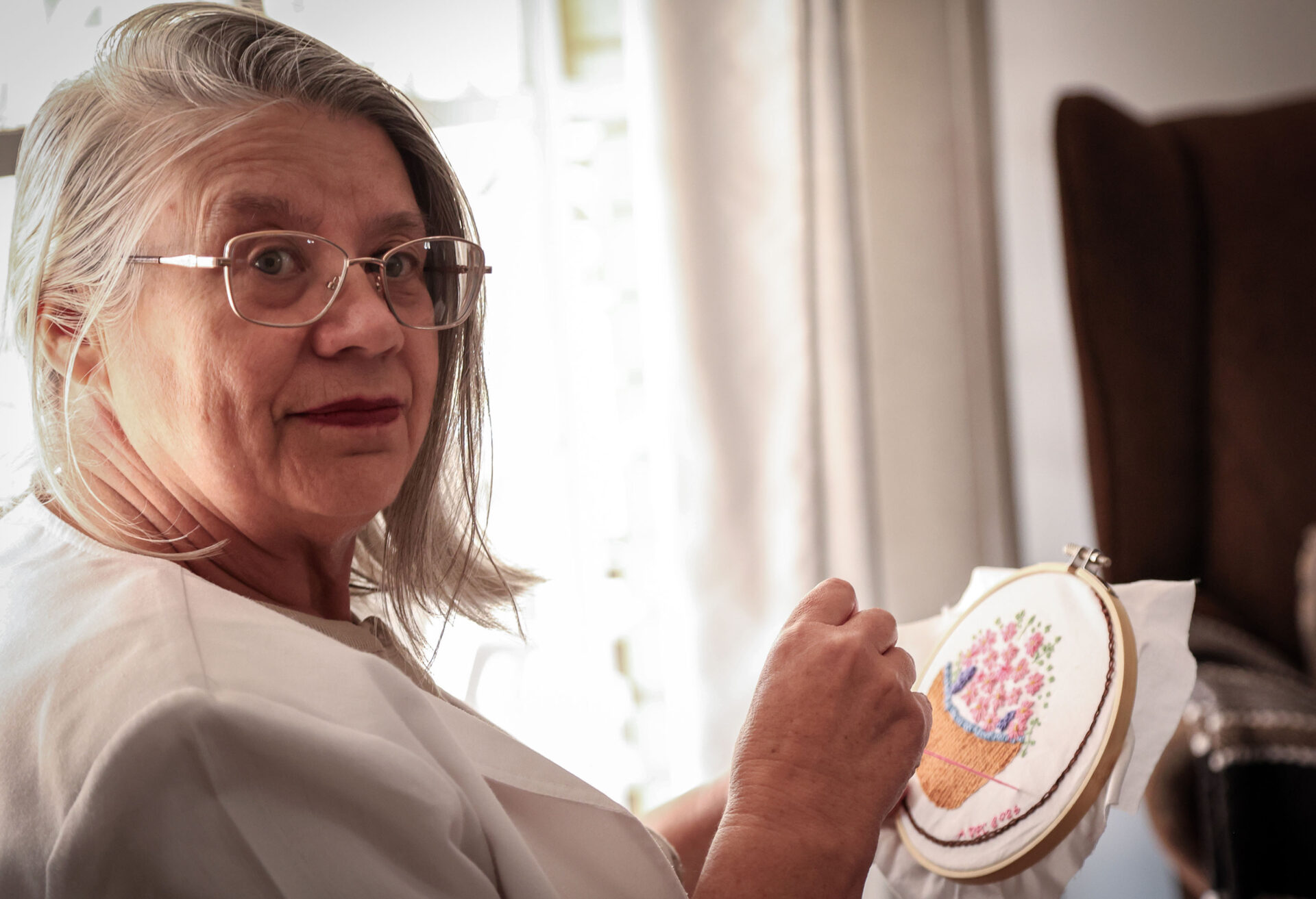 Andrieka de Clerk spends time embroidering flowers.
